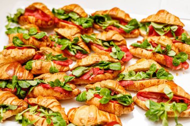 Croissant with basil, prosciutto, and mozzarella fillings. Top view