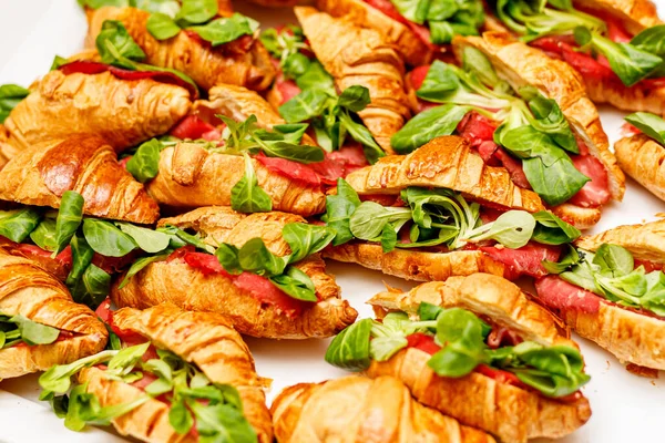 Croissant with basil, prosciutto, and mozzarella fillings. Top view