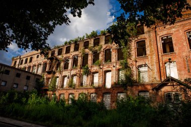 Red brick facade of an abandoned factory