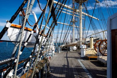 Wooden deck of an old sail ship, sailboat rigging
