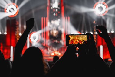 The crowd on a fan zone with the smartphone to record or take pictures during the live concert