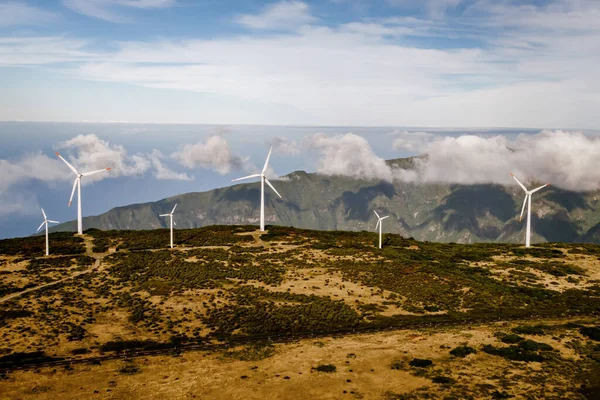 stock image Wind turbines for green energy in a windy place high in the mountains above the clouds