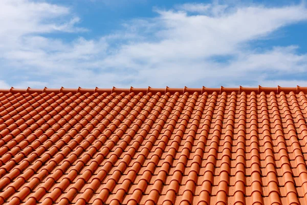 stock image Red tiles panels roof under blue sky