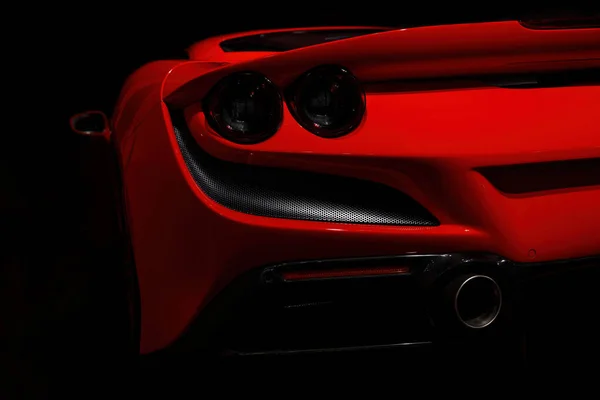 stock image Close-up of rear lights of Red sports car on the dark background