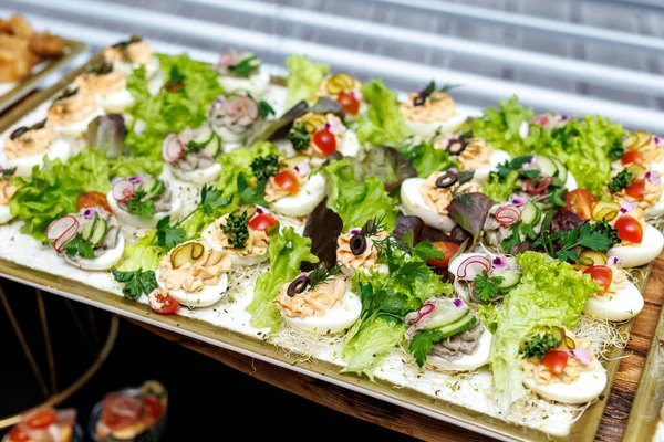 stock image Boiled egg halves with mayonnaise and green onions at the buffet. Event catering