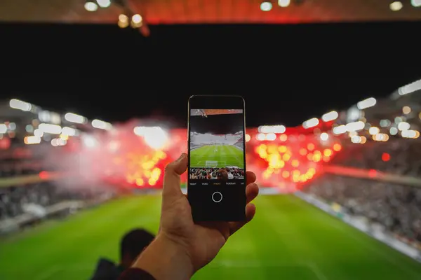 Mobile phone photography of the fan sector performance during a football match