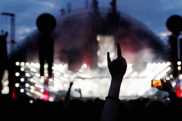 Silhouette of Rock and Roll hand sign against concert stage light