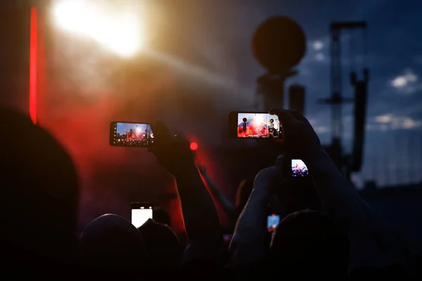 Taking photo or video content for social networks at the concert, Mobile phone on music show