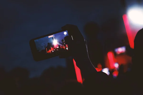 Streaming from the dance floor via mobile phone during a concert show.