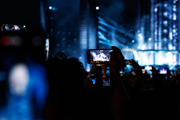Streaming from the dance floor via mobile phone during a concert show.