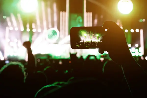 Taking a photo or video content at a music concert using a cell phone