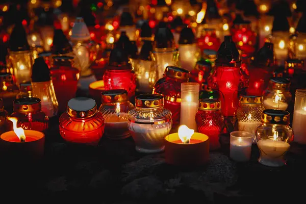Many memory candles burn during dark night
