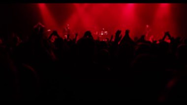 Crowd, happy people enjoying a rock concert, raised up hands and clapping with pleasure