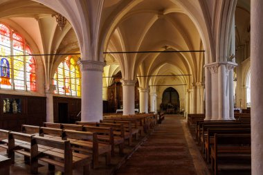 Kilise çok uzundur ve birçok sıraları vardır. Sıralar boş.