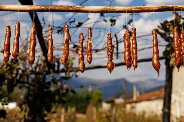 Tahta kirişe asılı bir et yığını. Et kahverengidir ve tatlı bir kokusu vardır.
