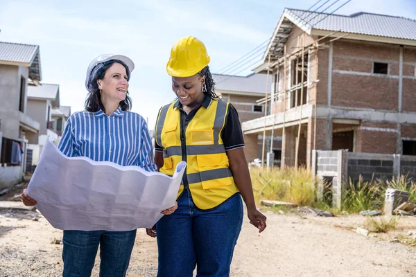 portrait of female construction worker and engineer in construction site