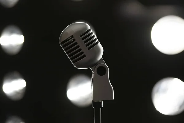 microphone on a stand close-up against the background of spotlights