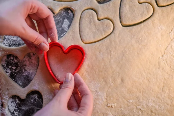 the chef prepares shortbread cookies in the shape of a heart