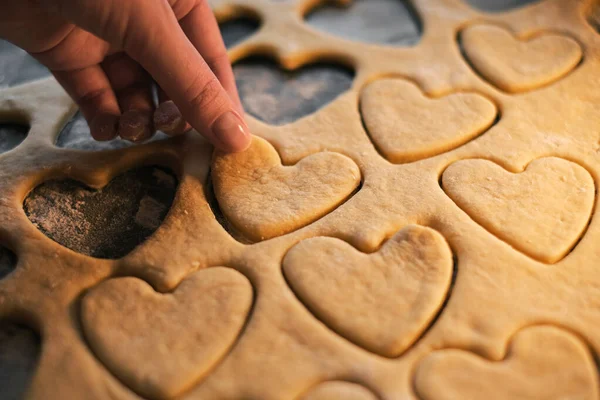 the chef prepares shortbread cookies in the shape of a heart