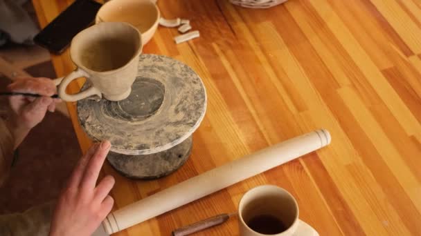 陶芸の工房で女性陶芸家が粘土でカップを作って — ストック動画