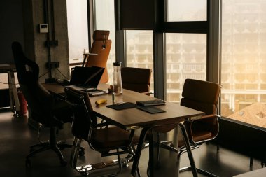 empty desks workspaces in coworking space clipart