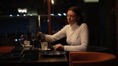 Restoranda çay içen genç bir kadın.