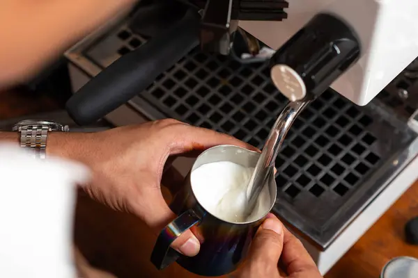 stock image Barista Steaming Milk With a Coffee Machine Pitcher in a Modern Cafe