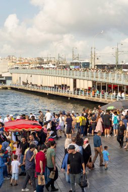 Istanbul, Turkey - August 30, 2022: Crowds of local citizens and tourists at Eminonu Piazza during the Victory Day holiday with background of Istanbul city view including Galata Bridge