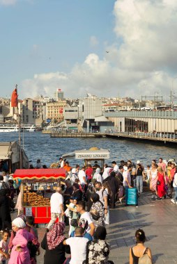 Istanbul, Turkey - August 30, 2022: Crowds of local citizens and tourists at Eminonu Piazza during the Victory Day holiday with background of Istanbul city view including Galata Bridge