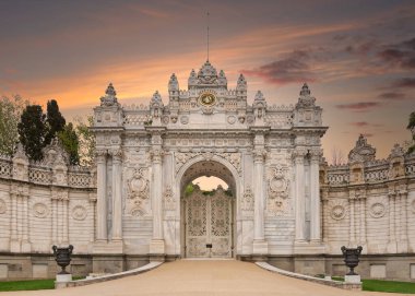 Sunset shot of closed gate leading to former Ottoman Dolmabahce Palace, or Dolmabahce Sarayi, suited in Ciragan Street, Besiktas district, Istanbul, Turkey. View from the internal court clipart