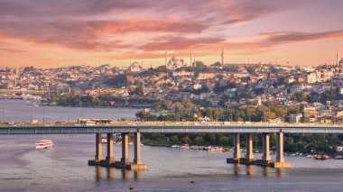 Aerial view from Pierre Loti popular hilltop park of the Halic Bridge, spanning the Golden Horn in Istanbul, Turkey, with background of city skyline, with historic mosques towering above the city clipart