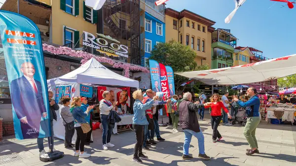 stock image Istanbul, Turkey - May 13 2023: People dancing in front of Republican Peoples Party kiosk in the neighbourhood of Ortakoy during the 2023 elections