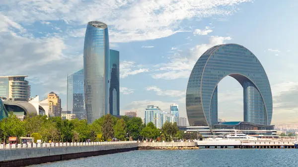 Bakü, Azerbaycan - 10 Mayıs 2024: Hilal Geliştirme Projesinde, Hazar Denizi kıyısındaki Bakü Bulvarı 'nda açık gökyüzüne karşı Crescent Hotel de dahil olmak üzere modern mimari yer alıyor. 