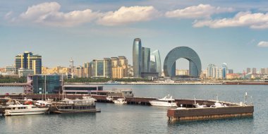 Baku, Azerbaijan - May 4, 2024: A view of the Caspian Sea coast featuring modern architecture, marina, and the Crescent Development Project clipart