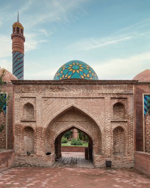 The grand entrance of the Imamzadeh Mausoleum complex in Ganja, Azerbaijan, features intricate brickwork and colorful tile patterns, reflecting rich cultural heritage clipart