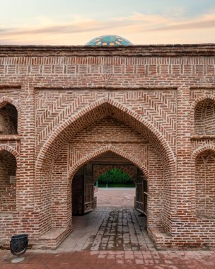 The majestic entrance of the Imamzadeh Mausoleum complex in Ganja, Azerbaijan, showcases elaborate brickwork and vibrant tile designs, embodying a rich cultural heritage. clipart