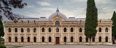 The Mahsati Ganjavi Center stands majestically in Ganja, Azerbaijan, reflecting its cultural significance and historical architecture. Visitors admire the intricate designs and serene surroundings clipart