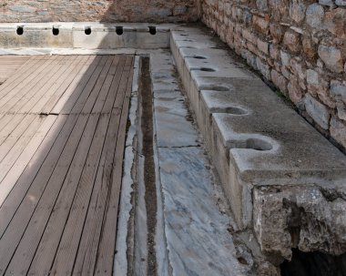 Efes, Selcuk, İzmir 'deki umumi tuvaletlerin kalıntıları, antik Yunanlıların sağlık hizmetlerini nasıl yönettiklerini ortaya çıkarıyor. Bu arkeolojik alan, tarihi bir şehirde hijyen için kullanılan kamu tesislerini vurguluyor