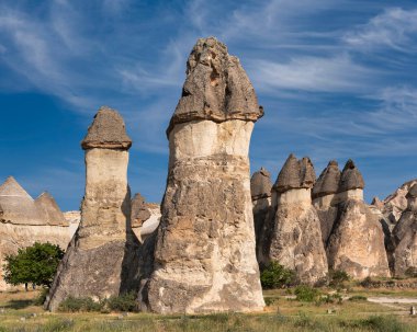 Pasabag Valley, Cappadocia, Turkey. Unique fairy chimney rock formations under a bright blue sky with cirrus clouds. Natural landscape