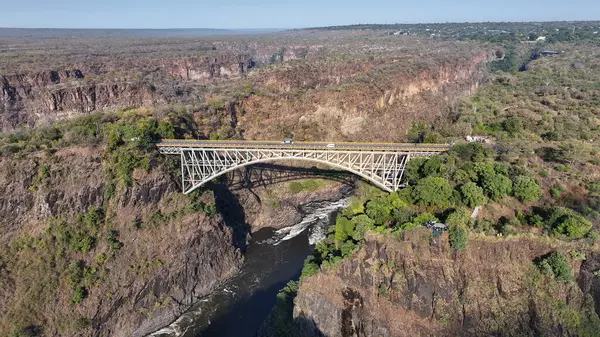 stock image Victoria Falls Bridge At Victoria Falls In Matabeleland North Zimbabwe. Landmark Bridge. Zambezi River Landscape. Victoria Falls At Matabeleland North Zimbabwe. Southern Africa. Tourism Travel.