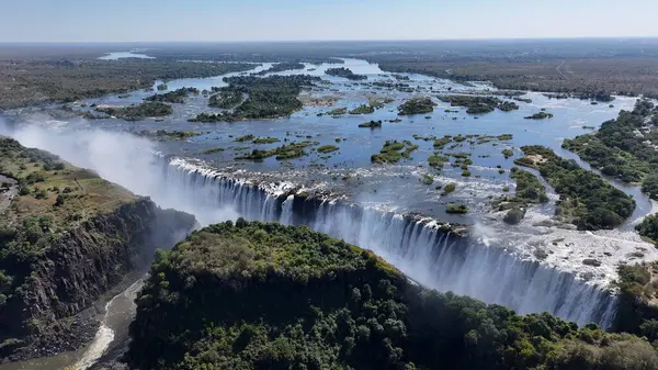 stock image Victoria Falls At Livingstone In Northern Rhodesia Zambia. Nature Waterfall. Zambezi River Landscape. Livingstone At Northern Rhodesia Zambia. Southern Africa. Tourism Travel.