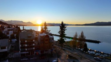 Rio Negro Arjantin 'deki San Carlos de Bariloche' de günbatımı gökyüzü. Sahne Suyu. Şehir merkezinde. Çarpıcı şehir manzarası. Rio Negro Arjantin 'de San Carlos De Bariloche' de Günbatımı Skyline.