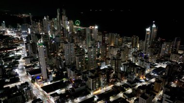 Night City At Camboriu In Santa Catarina Brazil. Downtown District. Illuminated City. Highrise Buildings. Night City At Camboriu In Santa Catarina Brazil. clipart