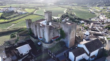 Portekiz 'in Obidos Leiria bölgesindeki Obidos Kalesi. Yukardan bakıldığında hareketli bir şehirde ortaçağ binası. Şehir merkezindeki İş Gökyüzü Arkaplanı. Şehir Merkezi Panoramik Şirketi.