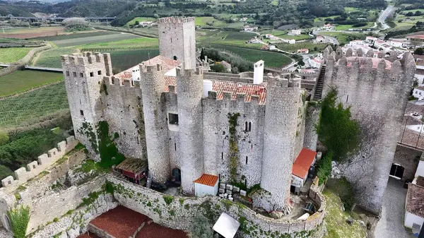 Portekiz 'in Obidos Leiria bölgesindeki Obidos Kalesi. Şehrin ünlü bölgesindeki ortaçağ binasının kuş bakışı görüntüsü. Metropolitan Peyzaj Ticari Binası Çarpıcı. Metropolitan Atılgan Kasabası.