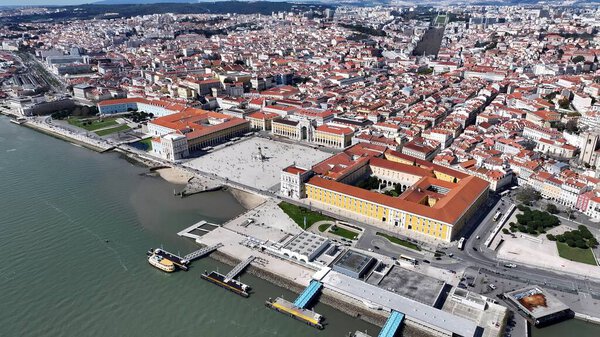 Comercio Square In Lisbon Portugal. Aerial View Of A Bustling City With High-Rise Buildings And Traffic. Business Sky Downtown Cityscape. Business Backgrounds Famous. Lisbon Portugal.