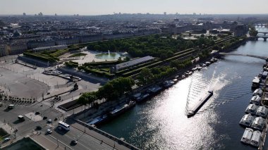 Fransa 'nın Paris şehrindeki Tuileries Bahçeleri. Etrafı yemyeşil tropikal yağmur ormanlarıyla çevrili bir nehrin havadan görünüşü. Metropolitan Peyzaj Ticari Binası Çarpıcı.