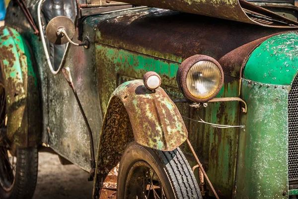 stock image A rusty old vintage car in need of renovation.