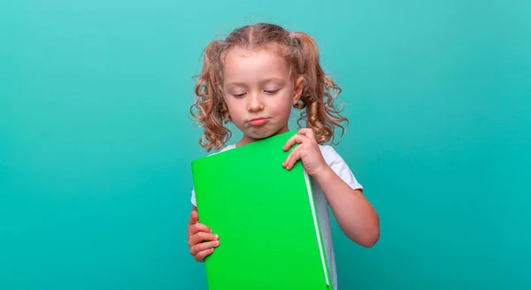 Sad Little Girl Book Her Hands Green Blue Background — Stock Photo, Image