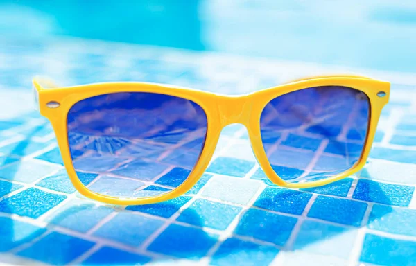 Yellow Sunglasses Background Pool Blue Water — Stock Photo, Image